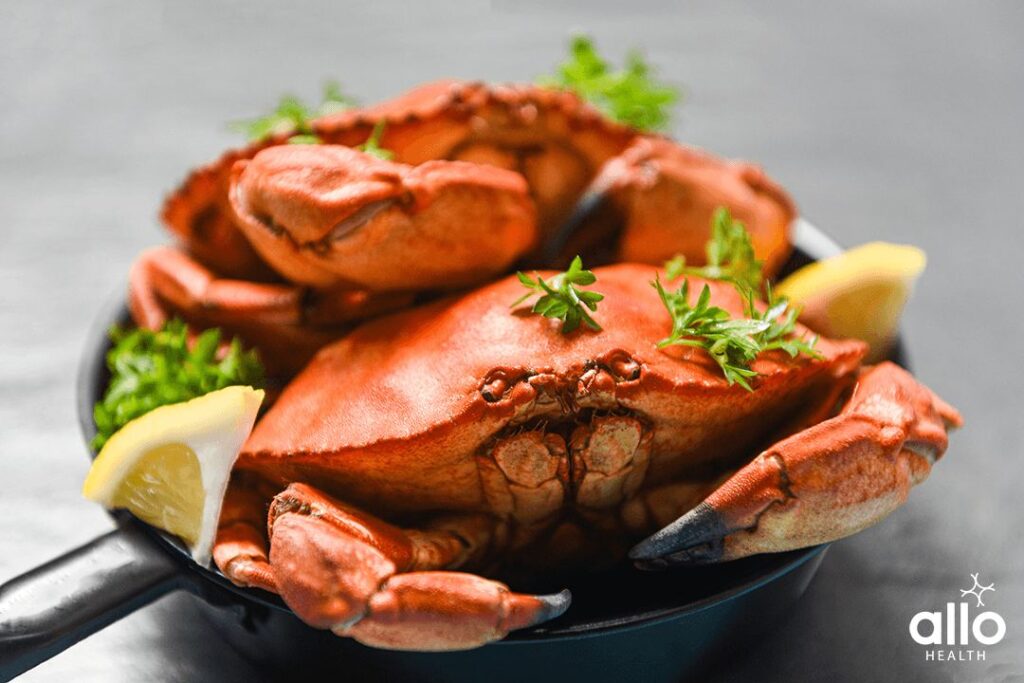 Cooked crab on hot pot and dark background - Seafood boiled red stone crabs