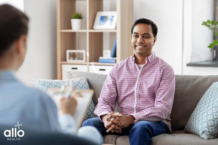 Man sitting and smiling after hearing about Erectile Dysfunction Treatment