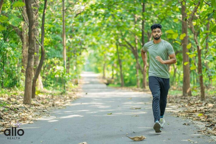Young man running in the park at morning