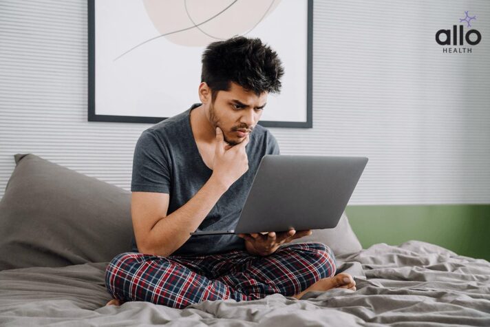 man checking in laptop for the causes of Premature Ejaculation