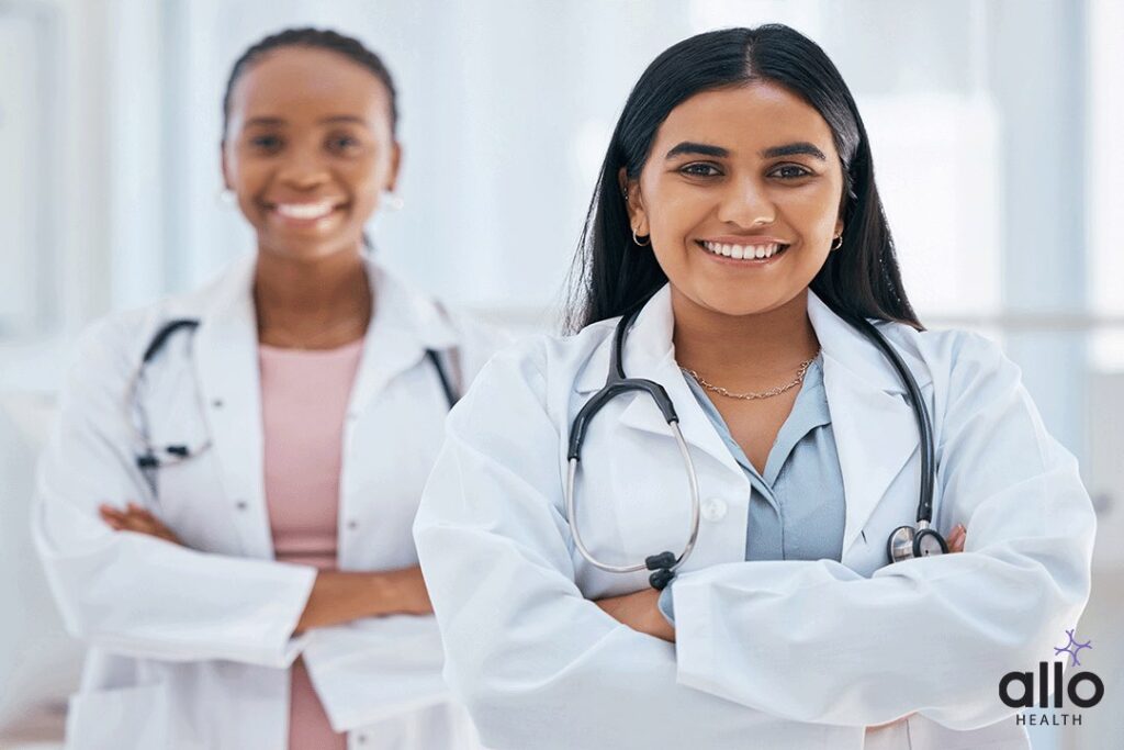 two doctors smiling and explaining how a woman can manage the Vulvodynia Symptoms