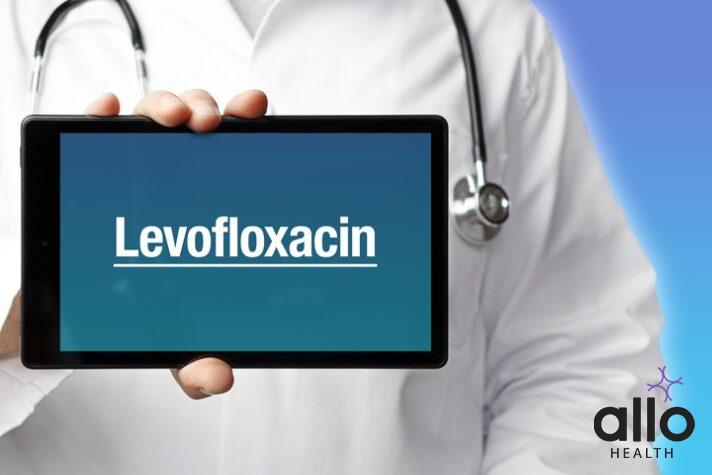 Levofloxacin. Doctor in smock holds up a tablet computer