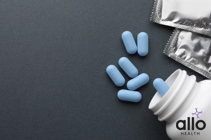 Pills and medical bottle on dark gray background, flat lay with space for text. Potency problem