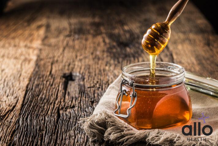 Honey jar with dipper on old woodn table. How to Use Honey for Erectile Dysfunction