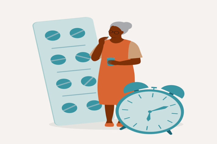 Black Elderly Woman Taking vitamin d tablets With A Glass Of Water.