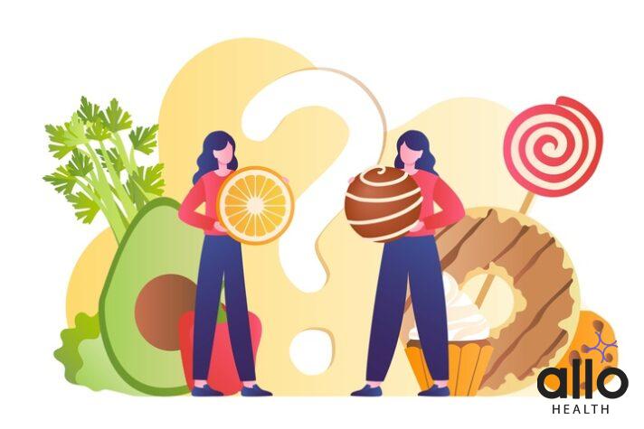 Vitamin E: Is There A Link To Sexual And Reproductive Health? 1 Vitamin Diet or Sweets. Woman with orange against young girl with candy. Comparison of healthy and unhealthy diet, proper nutrition. Junk vs natural products.