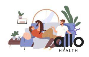 Happy couple with cat relaxing on sofa at home. Man and woman talking, playing with kitty, resting on cozy couch, What is important in relationship