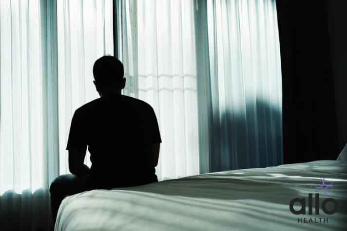 one sided relationship - Silhouette depressed man sadly sitting on the bed in the bedroom. Sad asian man suffering depression insomnia awake and sit alone on the bed in bedroom. Depression health people concept. ling ki samasya