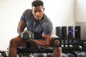 Black man, bodybuilder and dumbbell in gym portrait for fitness, focus or training for growth, goal or competition. African guy, weightlifting and strong arms for training, wellness and muscle health. does masturbation affect muscle gains