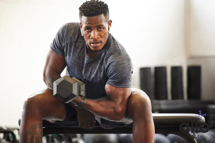 Black man, bodybuilder and dumbbell in gym portrait for fitness, focus or training for growth, goal or competition. African guy, weightlifting and strong arms for training, wellness and muscle health. does masturbation affect muscle gains, running premature ejaculation