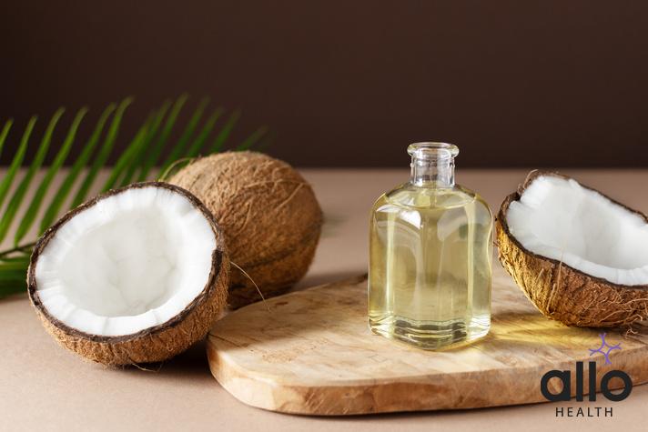 best oil for penis, Coconut oil with coconuts in the background, how to massage for erectile dysfunction