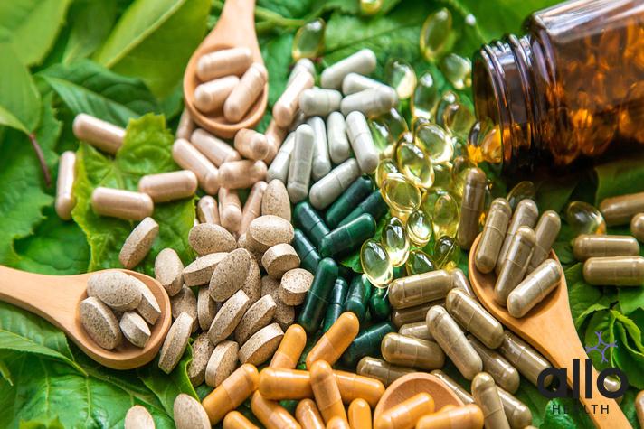 Capsules herb supplements on green leaves background. Selective focus. Green,, ashwagandha cholesterol