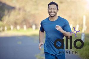 Man, smile in portrait and run outdoor, fitness and cardio with marathon, sports and athlete in nature. Asian male runner in road, happy with running exercise and training for race with mockup space.