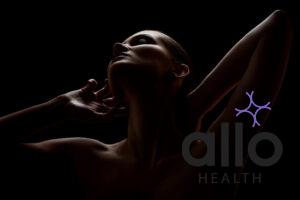 aroused meaning in hindi. aroused woman posing sensually holding head up on black background